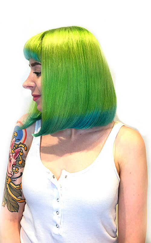 love-dip-after Hair model showing bright neon green hair with blue tips