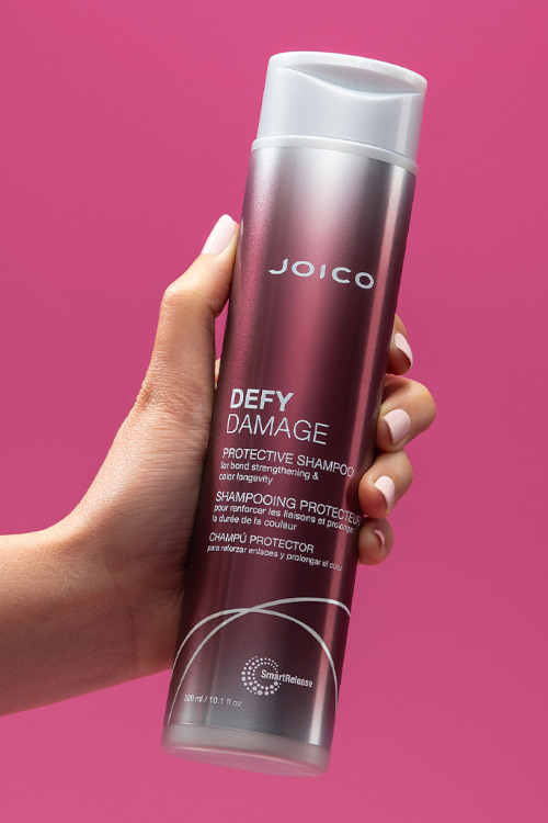 defy damage shampoo in hand
